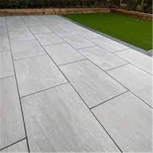 Porcelana Kandla Grey Porcelain Paving is a high-quality porcelain paving slab,
They are extremely hard-wearing and have the appearance of real natural mid-grey stone.
The product is designed to look just like a natural stone with varying grey tones and a surface that mimics a naturally texture.
It is Classic, chic and perfect to bring style to any outdoor space.
They are made from porcelain that is fired at high temperatures to create a hard, anti-slip, dense material that can withstand heavy foot traffic and exposure to the elements